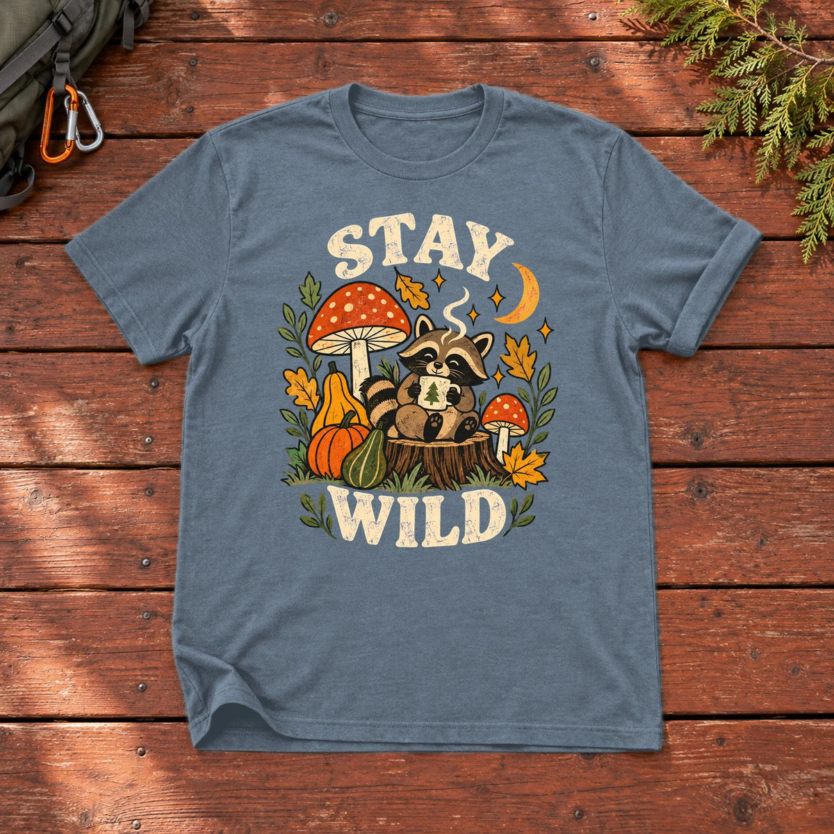 Cozy Autumn Raccoon Stay Wild Graphic Tee on Heather Indigo Everyday Soft Tee