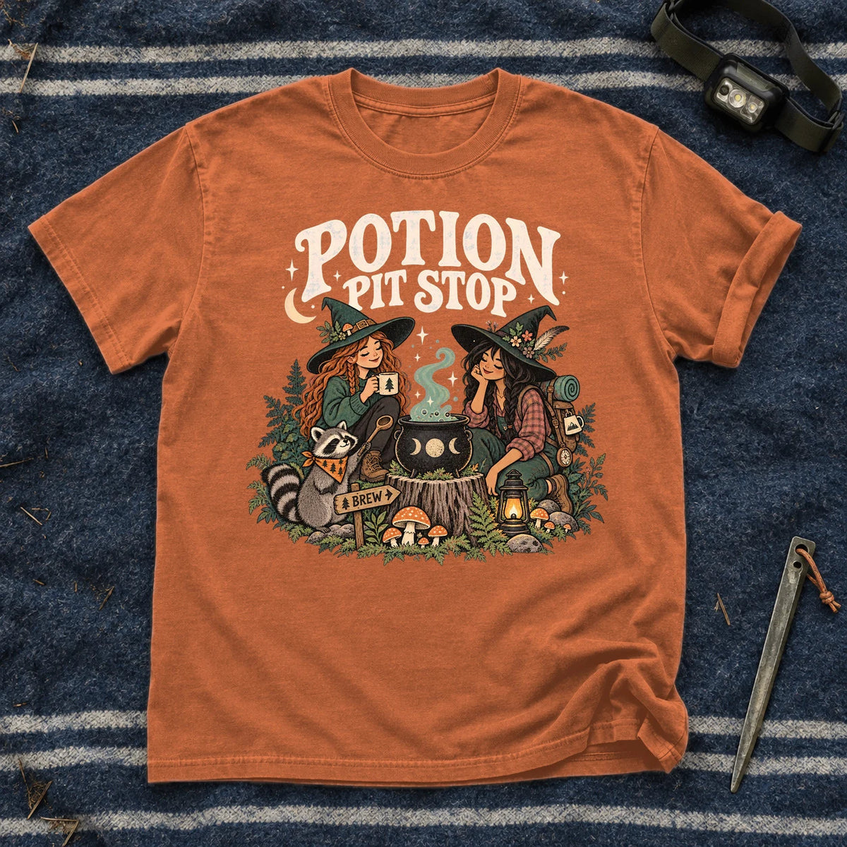 Potion Pit Stop Cozy Witch Graphic Tee on Yam Premium Tee