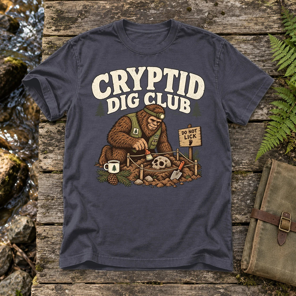 Cryptid Dig Club Graphic Tee on Navy Premium Tee