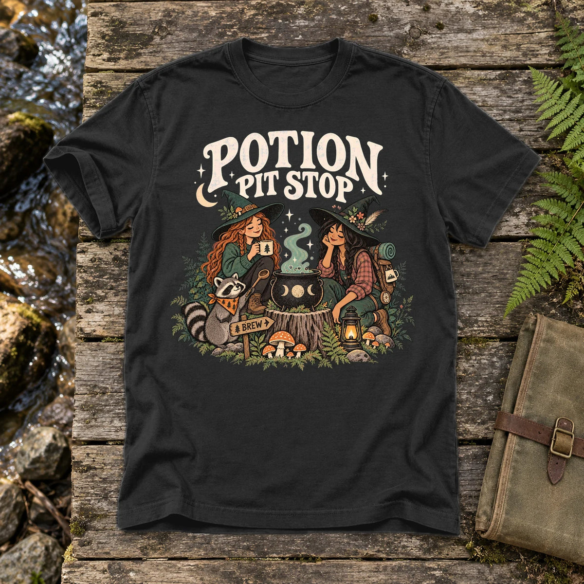 Potion Pit Stop Cozy Witch Graphic Tee on Black Premium Tee