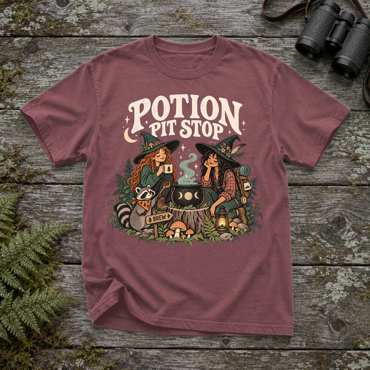 Potion Pit Stop Cozy Witch Graphic Tee on Brick Premium Tee