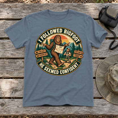I Followed Bigfoot Retro Hiking Graphic Tee on Heather Indigo Everyday Soft Tee