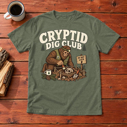 Cryptid Dig Club Graphic Tee on Military Green Everyday Soft Tee