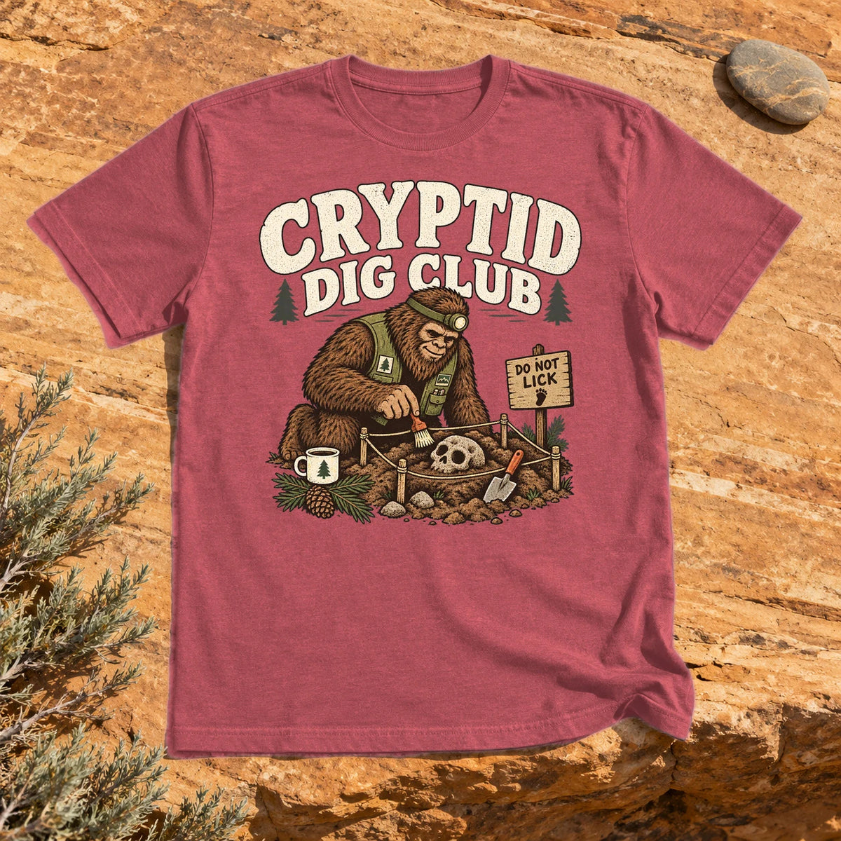 Cryptid Dig Club Graphic Tee on Heather Red Everyday Soft Tee