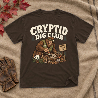 Cryptid Dig Club Graphic Tee on Dark Chocolate Everyday Soft Tee