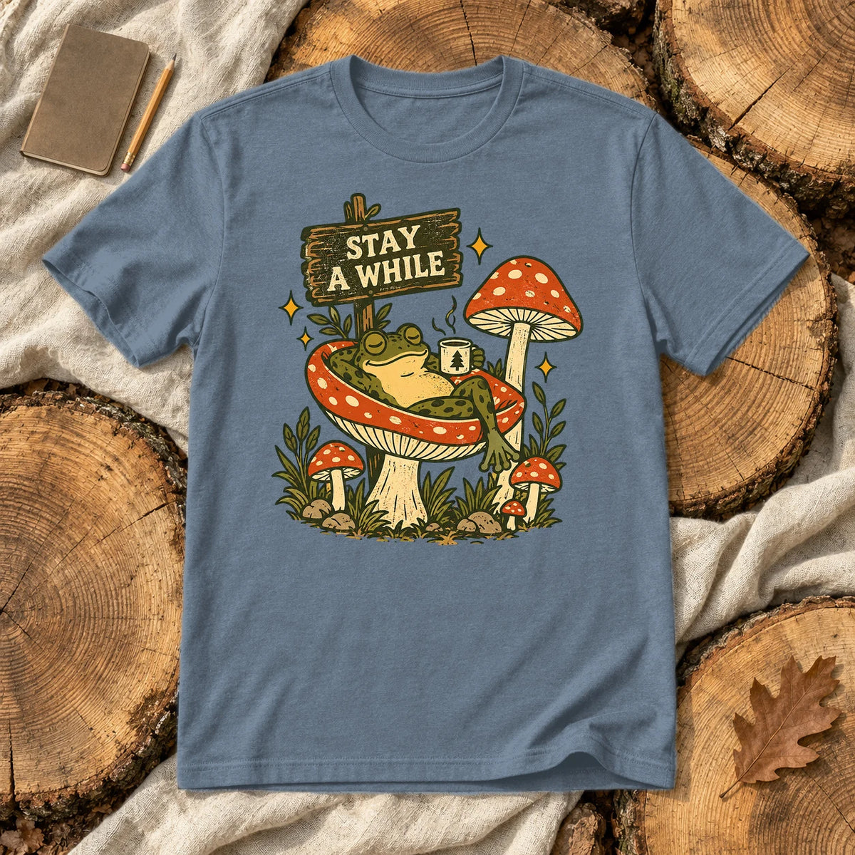 Stay A While Mushroom Frog Graphic Tee on Heather Indigo Everyday Soft Tee